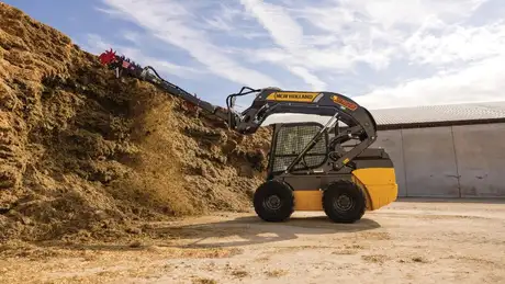 New Holland Construction L328 with sillage defacer attached.