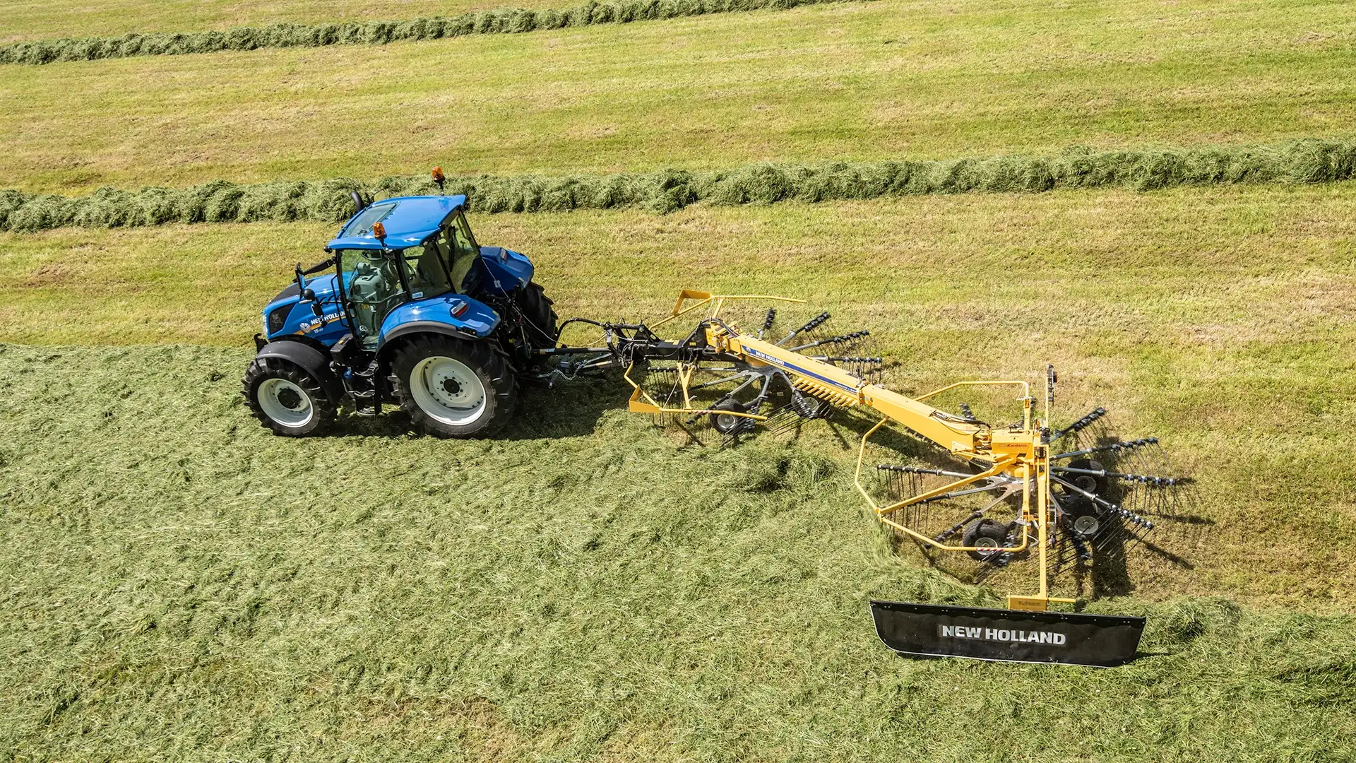 Tractor with Prorotor L Twin Rotor Rake working on the field