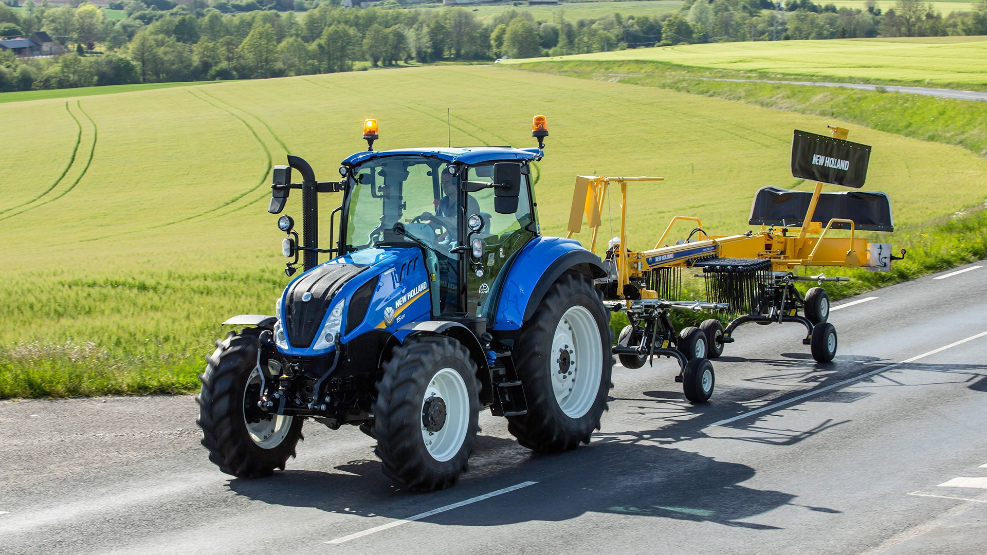 Tractor with Prorotor L Twin Rotor Rake on the road