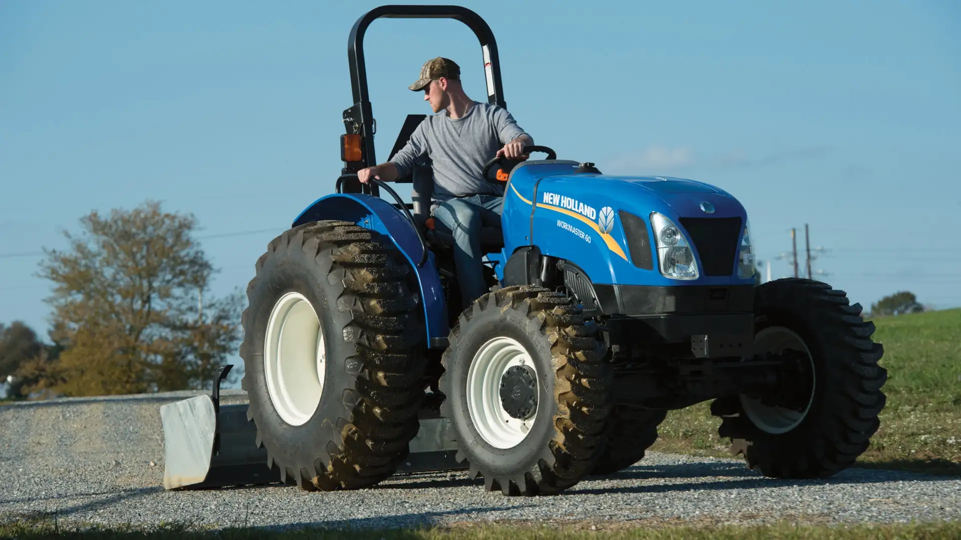 Man operates WORKMASTER tractor with ROPS platform