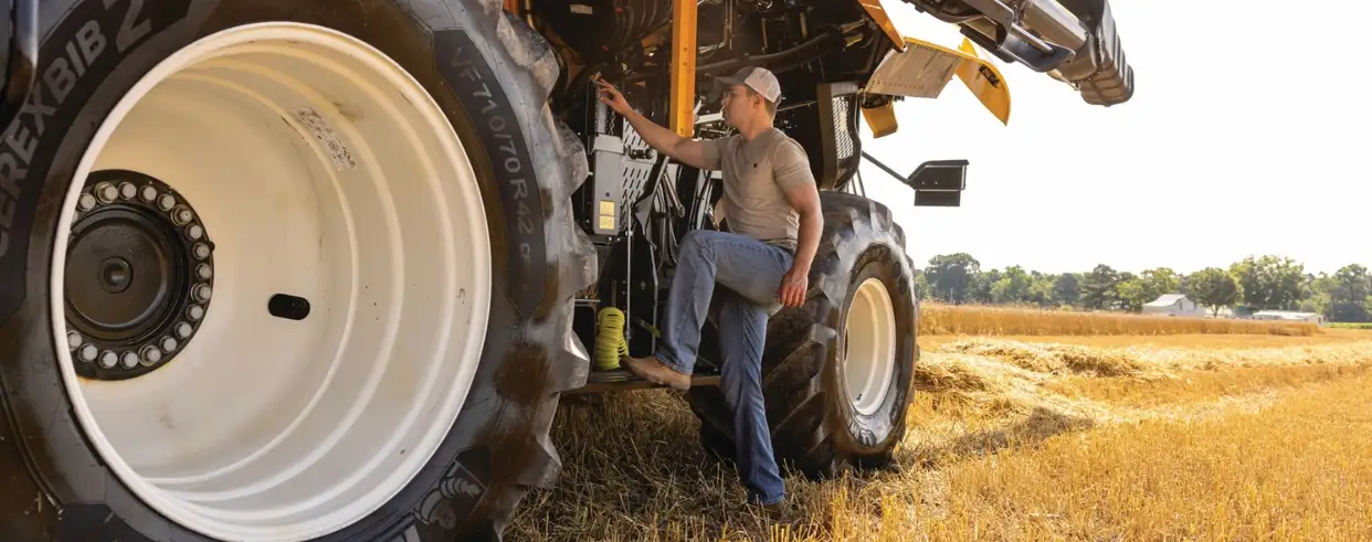 Operator steps onto a Next Generation CR Series combine