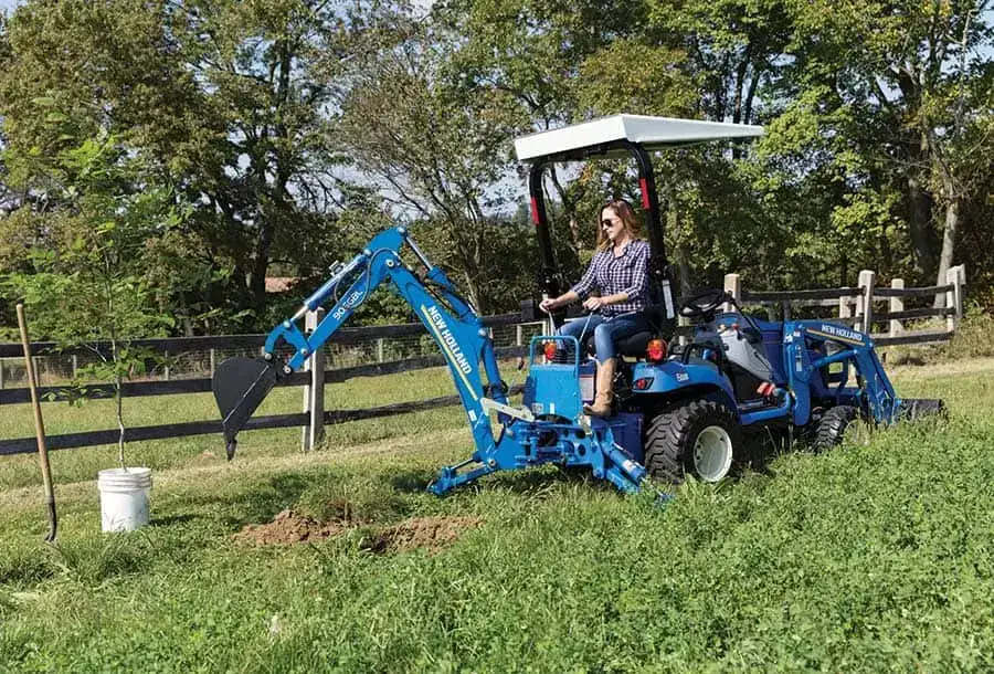 WORKMASTER™ 25S Sub-Compact with a backhoe attachment