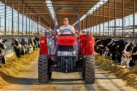 Man driving Farmall 75C tractor.