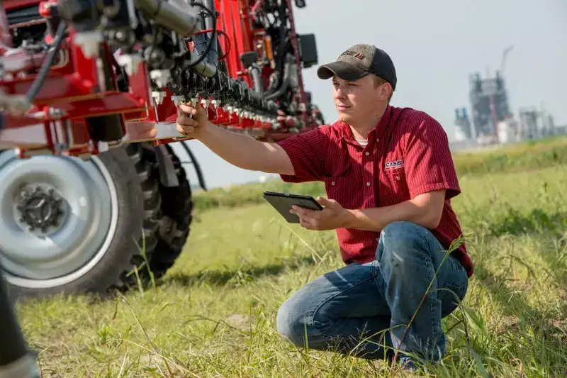 Case IH technician examining sprayer nozzles