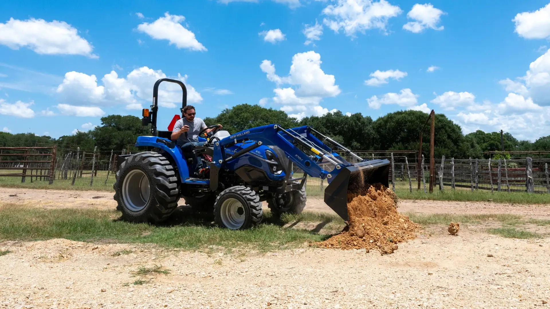 Tractor with loader moving a pile of dirt.