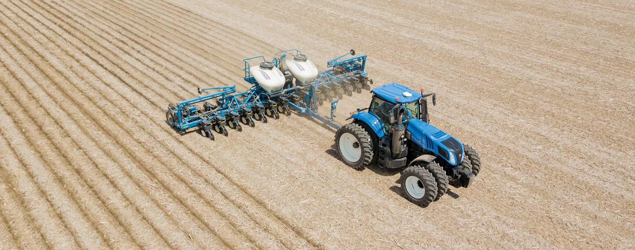 GENESIS® T8 Series pulling a seeding implement