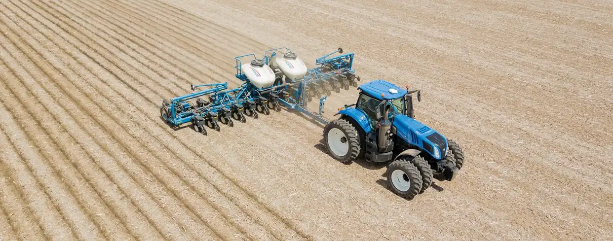 GENESIS® T8 Series pulling a seeding implement