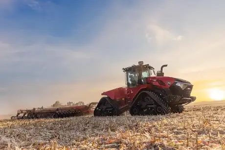 A high-horsepower Case IH Steiger 785 Quadtrac tractor pulling an implement in a field.