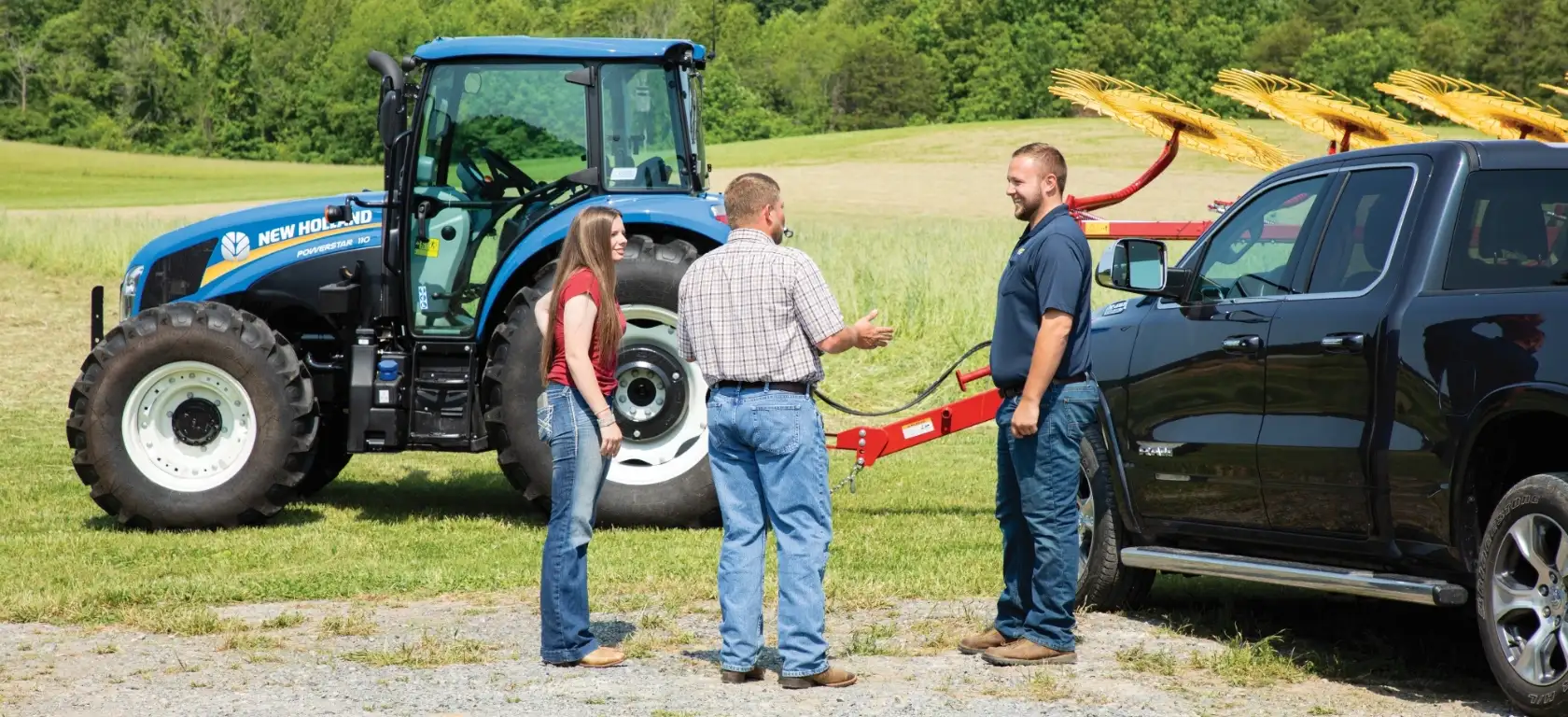 PowerStar Tractor parked with a hay rake implement