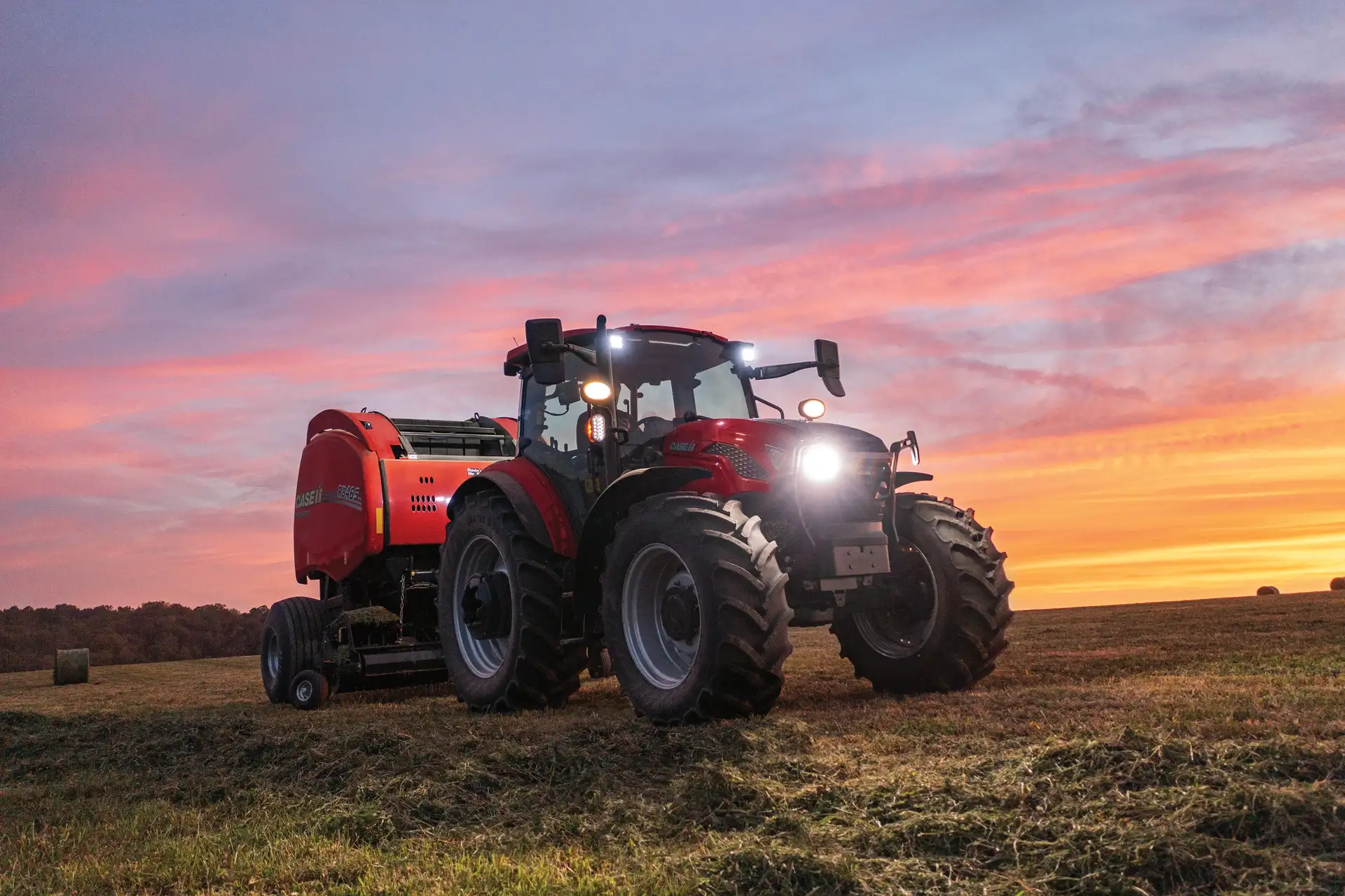 Farmall Utility 120C tractor with RB465 Round Baler.