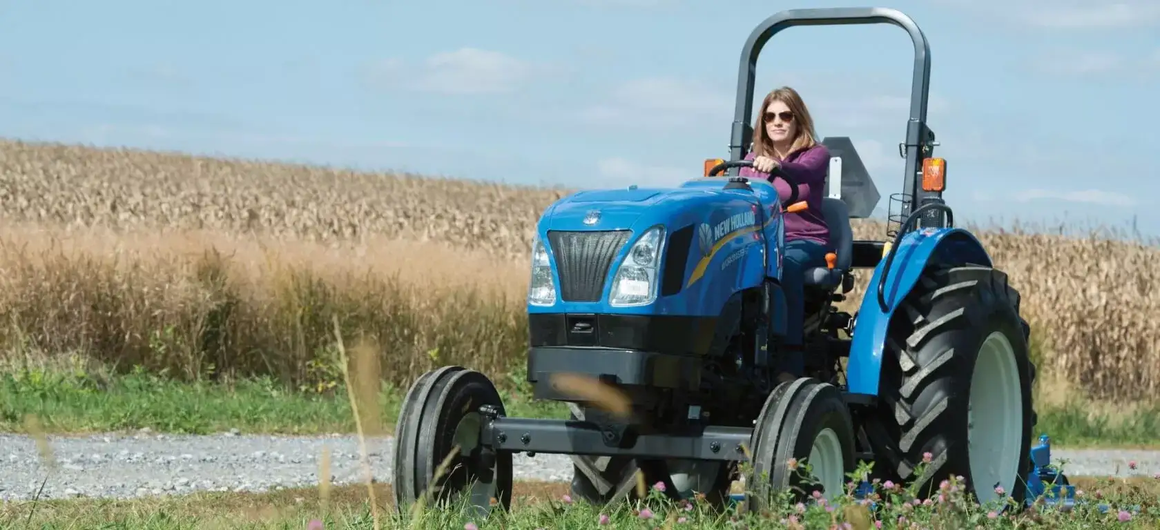 Woman operates WORKMASTER tractor in the field