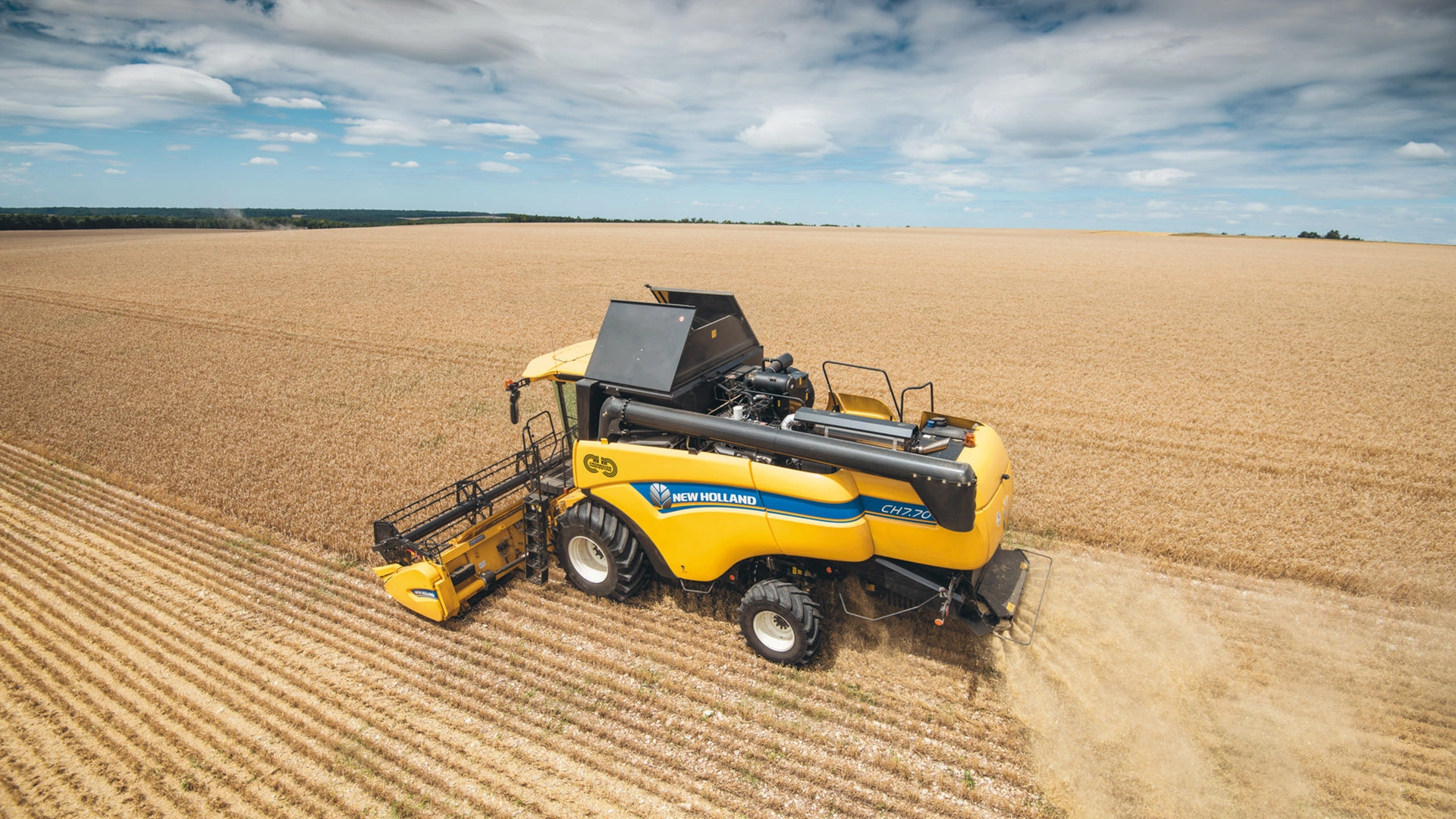 New Holland CH Combine Harvester in action, efficiently harvesting with agricultural combine header