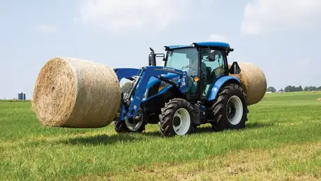 Workmaster™ 95, 105 and 120 series tractor lifts two round bales 