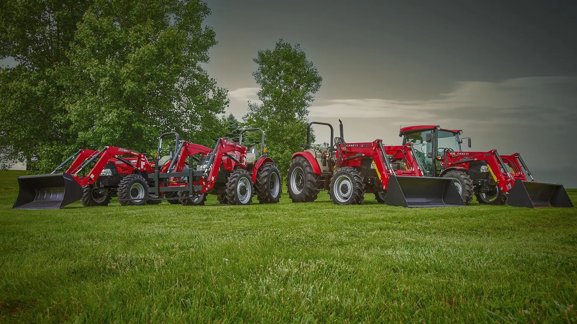 lineup of farmall tractors with front loader