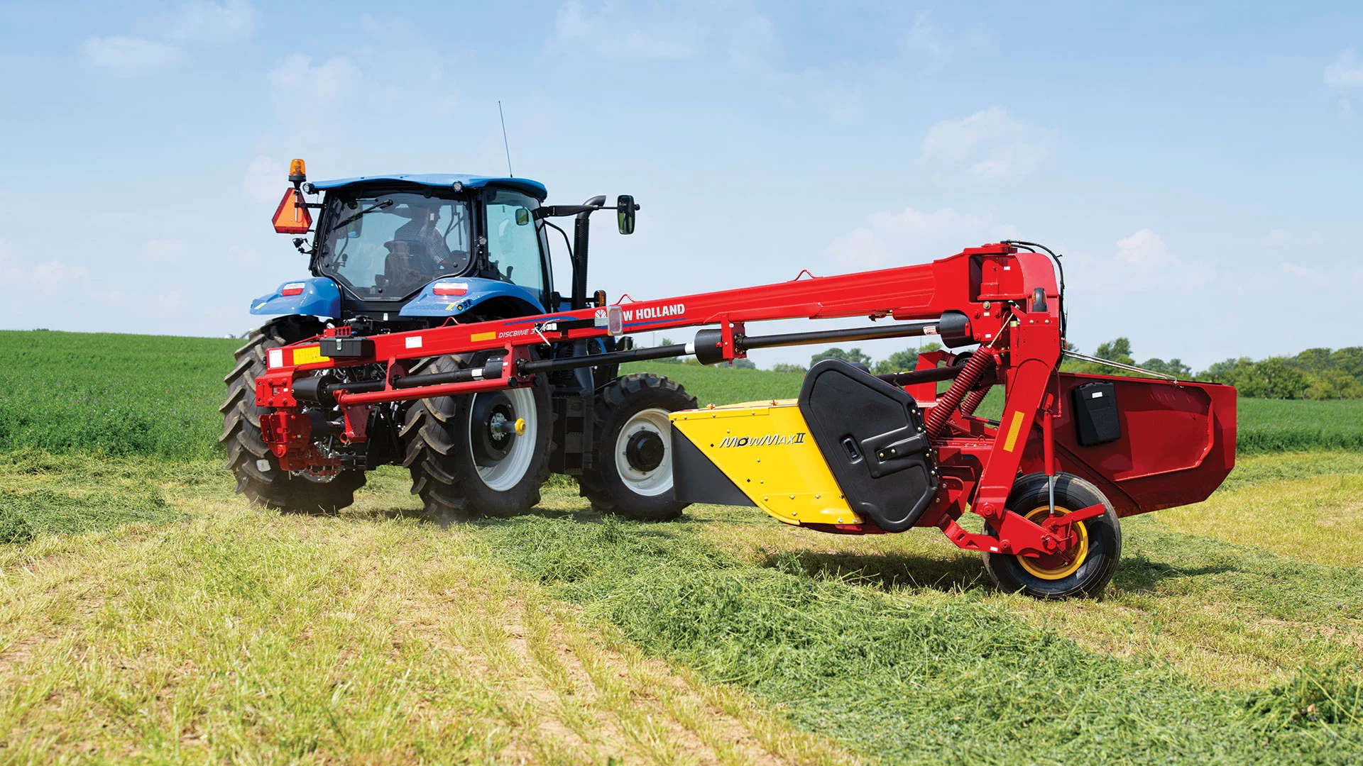 Tractor pulls a Discbine® PLUS Center-Pivot Disc Mower-Conditioner