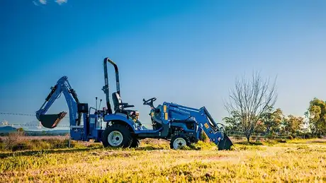 New Holland Boomer series tractor sitting in field