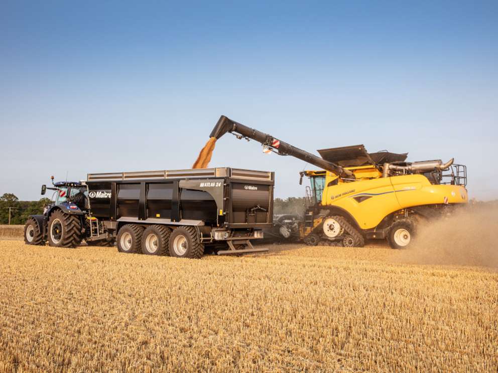 New Holland CR9.90 combine in field working whilst dispensing seeds