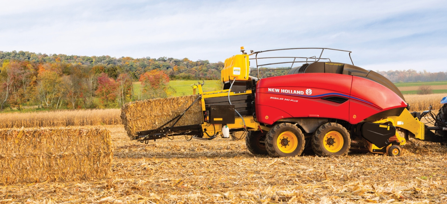 Tractor pulls a BigBaler PLUS Large Square Baler in the field