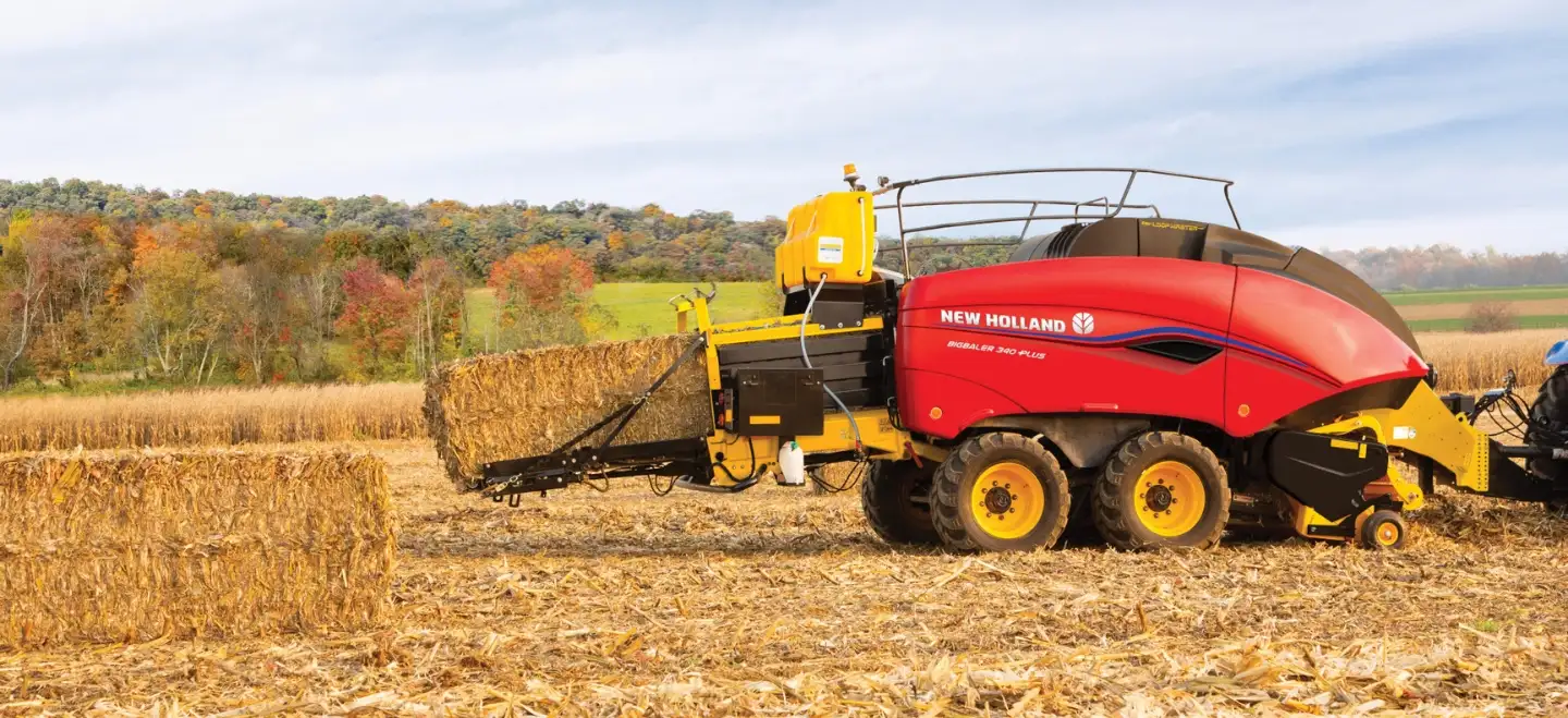 Tractor pulls a BigBaler PLUS Large Square Baler in the field