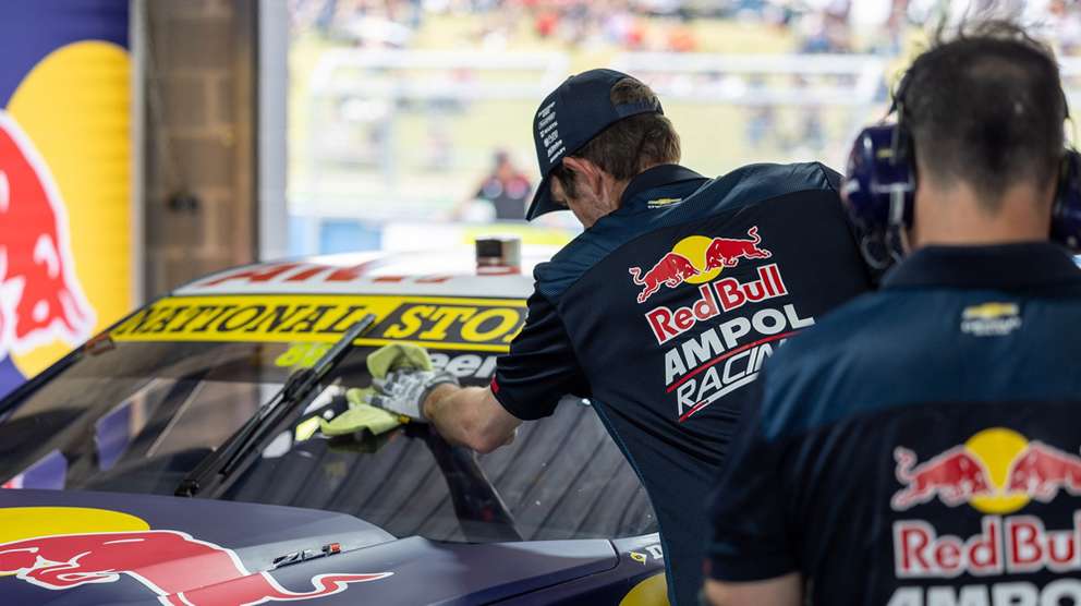 Redbull racing workshop mechanics working on car