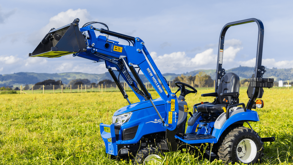 New Holland Boomer 25C with front loader working in field