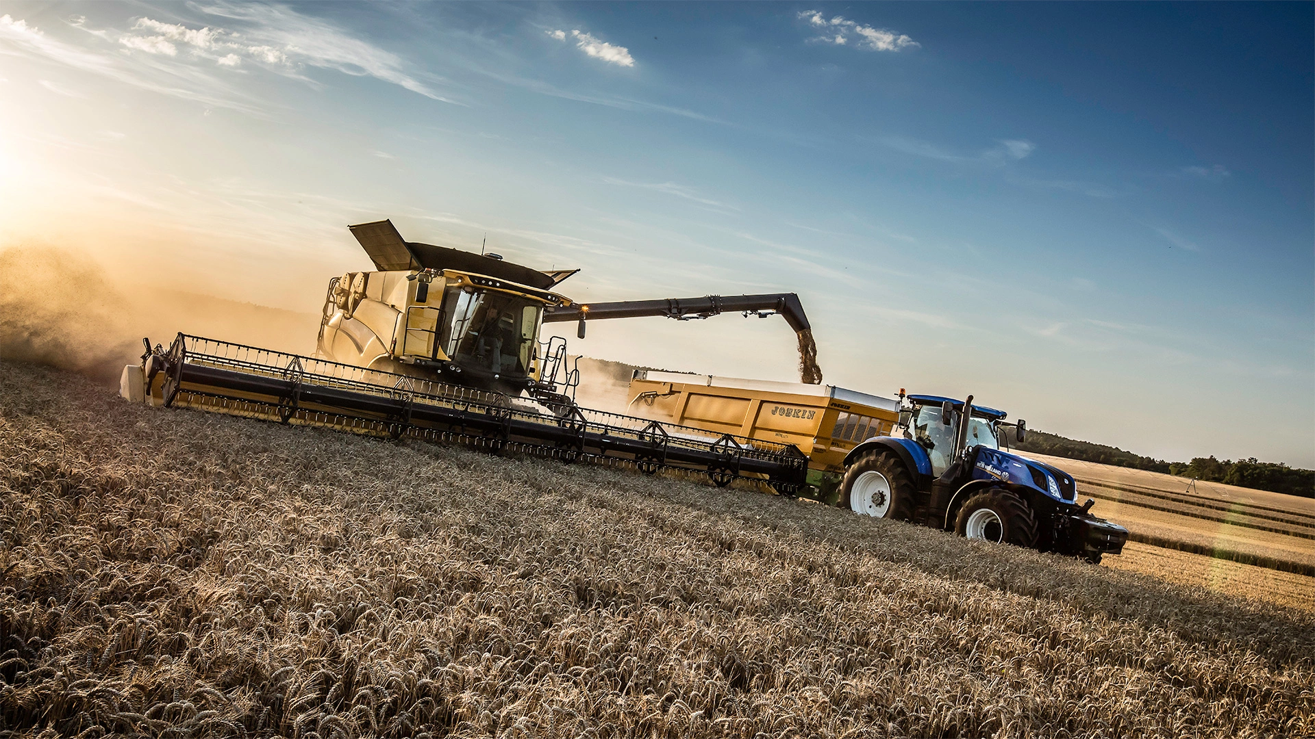 Integrated farming scene: New Holland's CR Revelation combine and tractors collaborating in the field