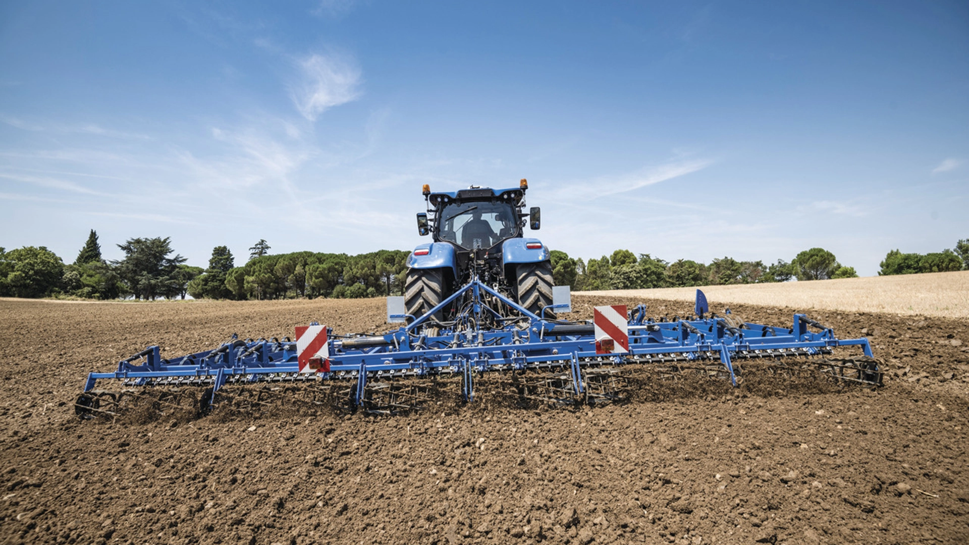 New Holland tractor operating seedbed cultivators for efficient soil cultivation on the field