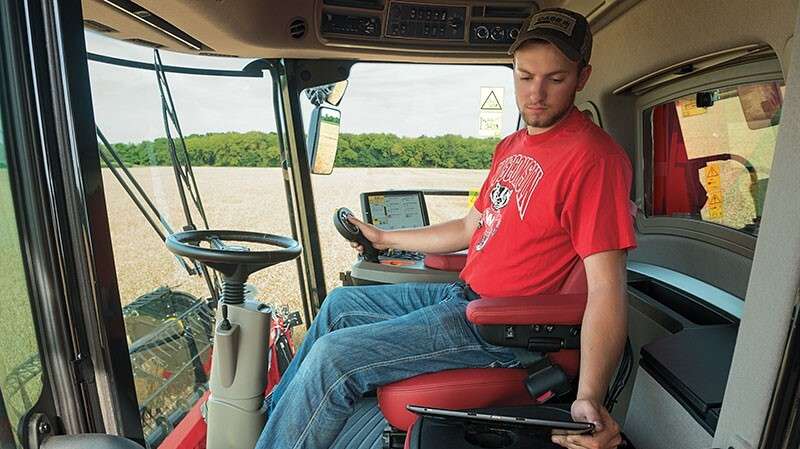 Producer in cab of Axial-Flow Combine
