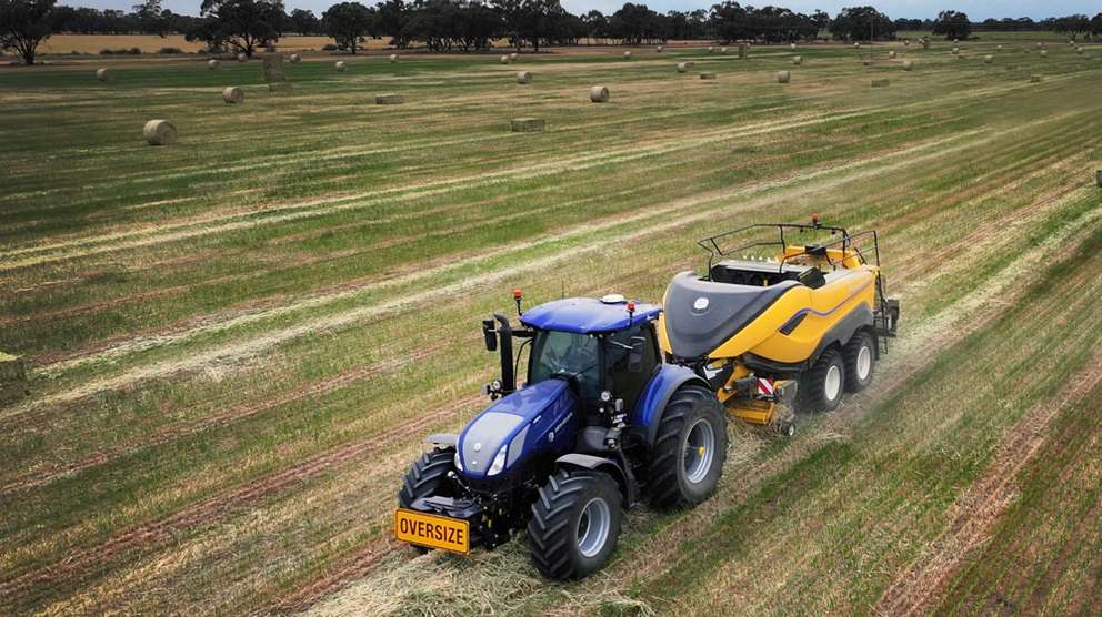 New Holland hay baler in field