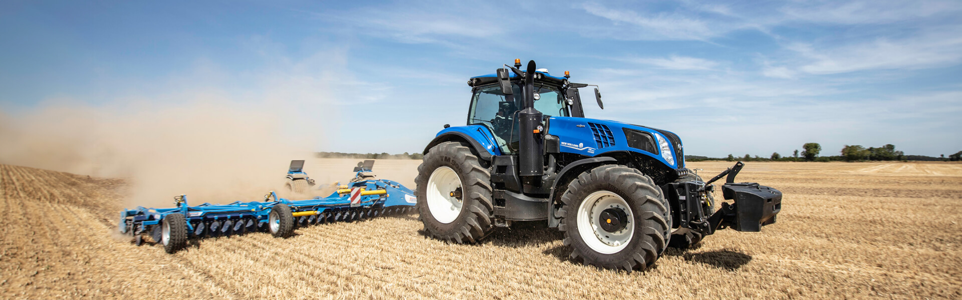 Blue New Holland T8 tractor working in field