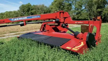 Red disc mower-conditioner in a field.