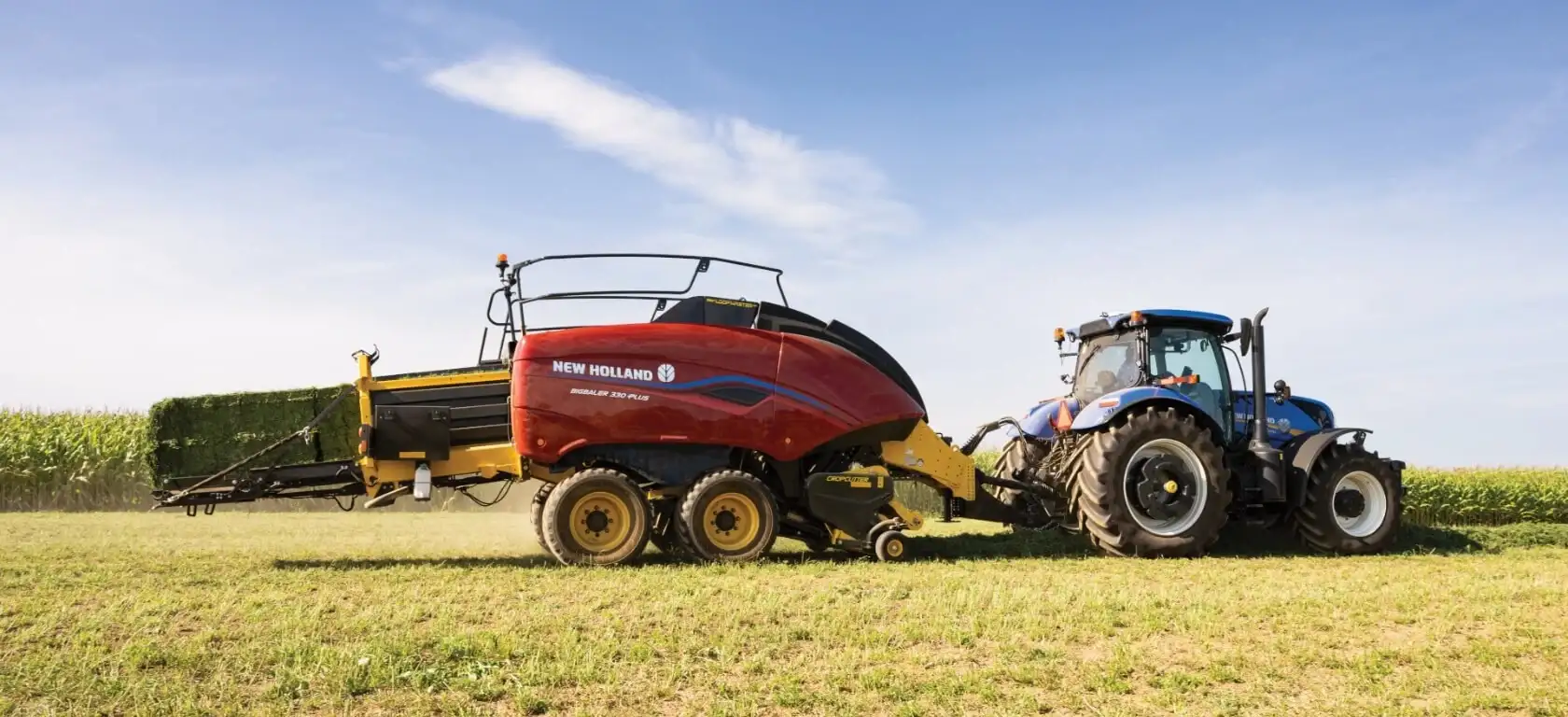 Tractor pulls a BigBaler PLUS Large Square Baler in the field