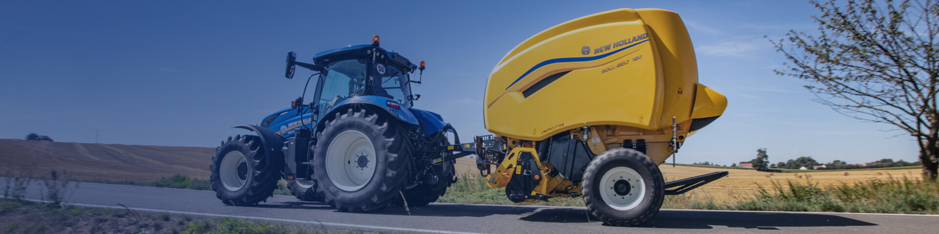 New Holland Roll-Belt with a tractor in field