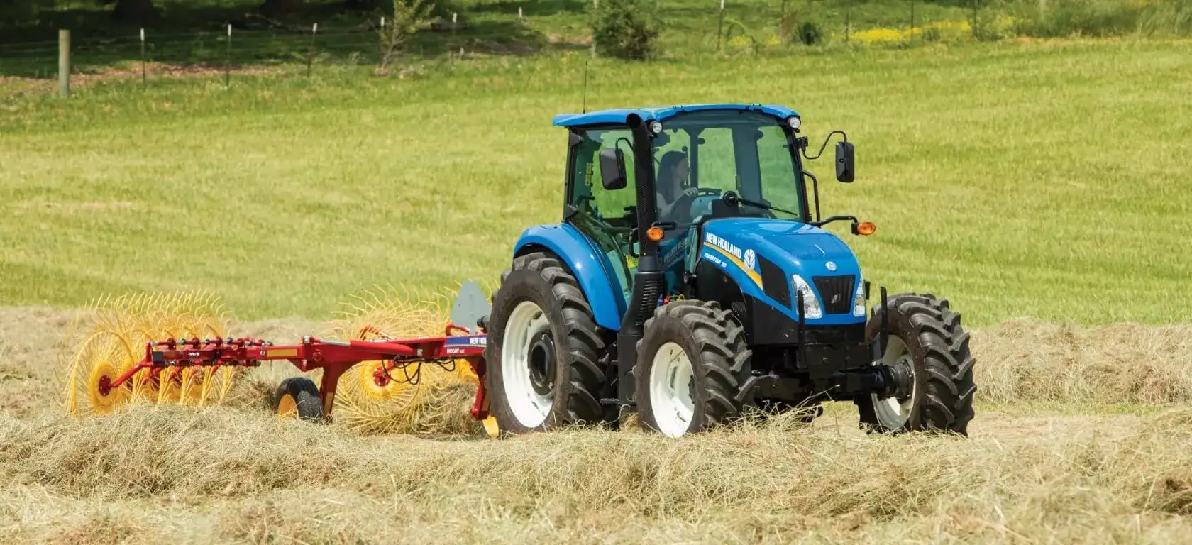 PowerStar Tractor pulls a hay rake