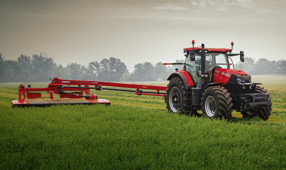 A Puma 260 tractor with a DC165  mower conditioner in a field.