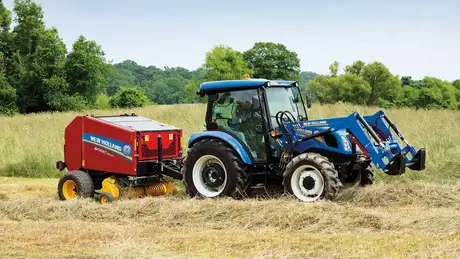 Workmaster™ Utility 55 – 75 Series tractor with a baler