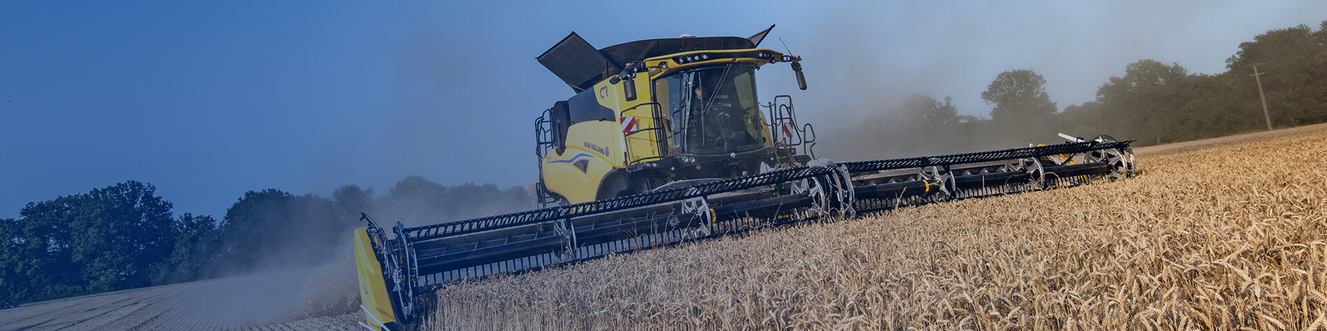 New Holland CR combine working in field with blue overlay