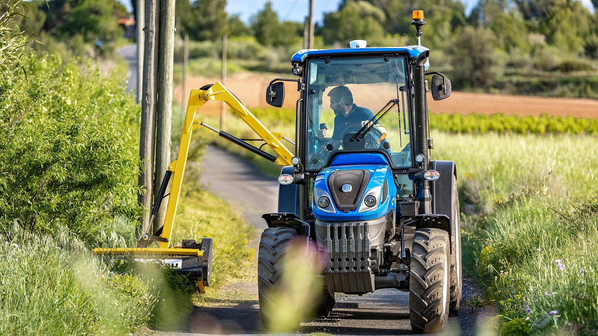 New Holland T4 FNV tractor with road sweeper