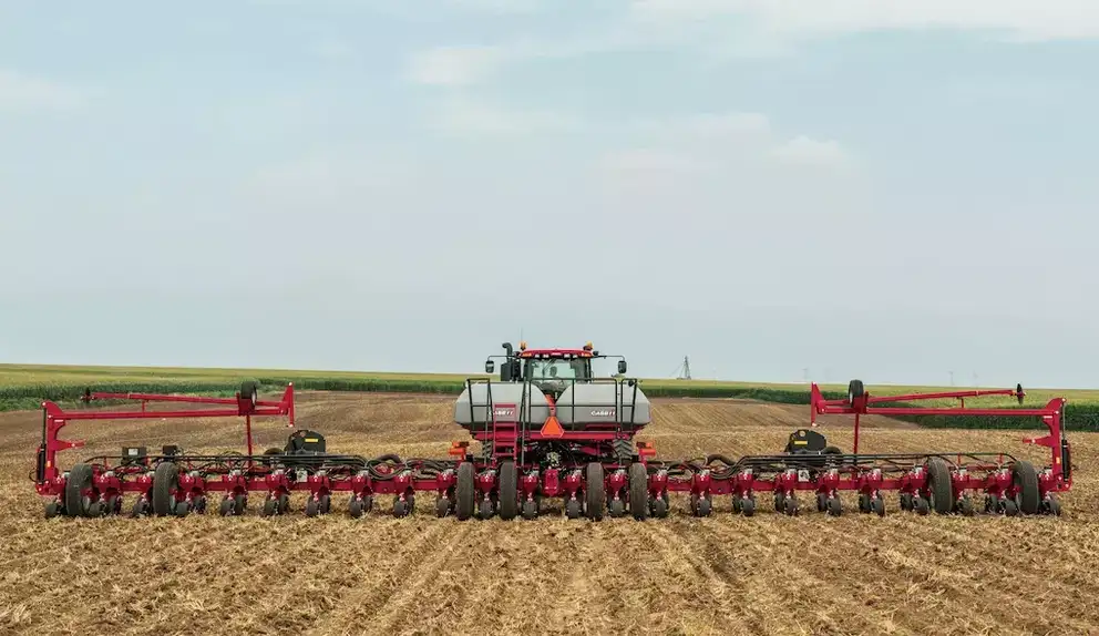 Image of a wide Case IH planter in green and brown field
