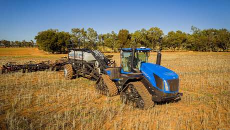 New Holland T9 SmartTrax configuration working in field with Flexi-Coil air cart attached to it