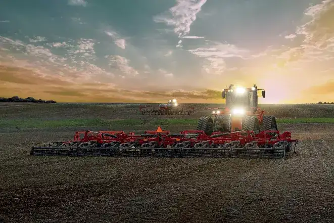 Steiger with Case IH Field Cultivator in sunset