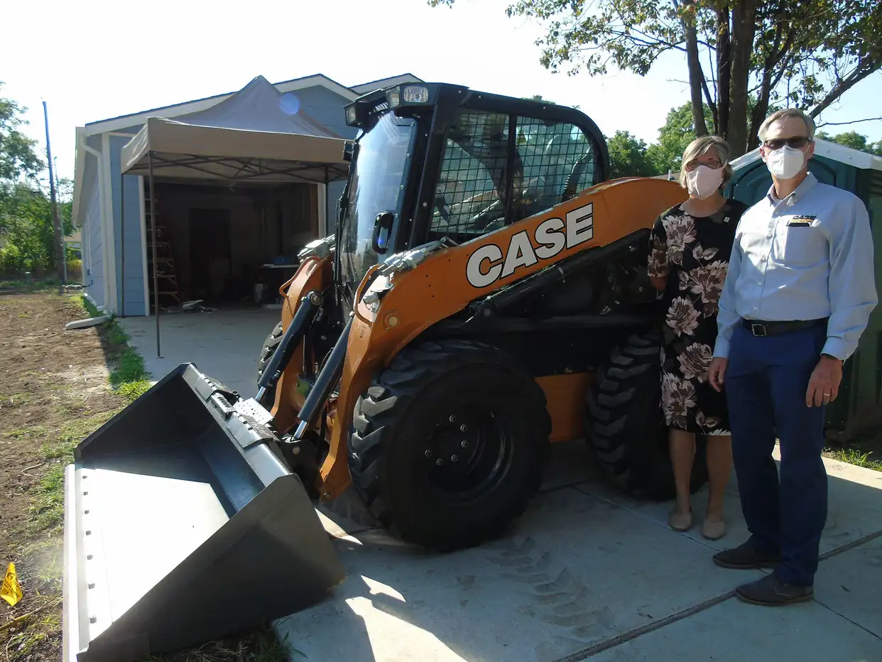 Ann-Fox-with-Habitat-and-Troy-Williams-with-CASE-and-the-donated-skid-steer