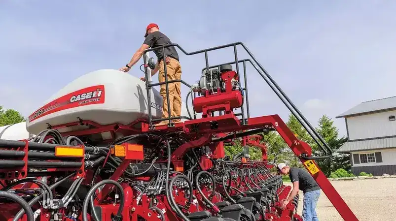 Case IH Technician on top of 2160 Early Riser Planter
