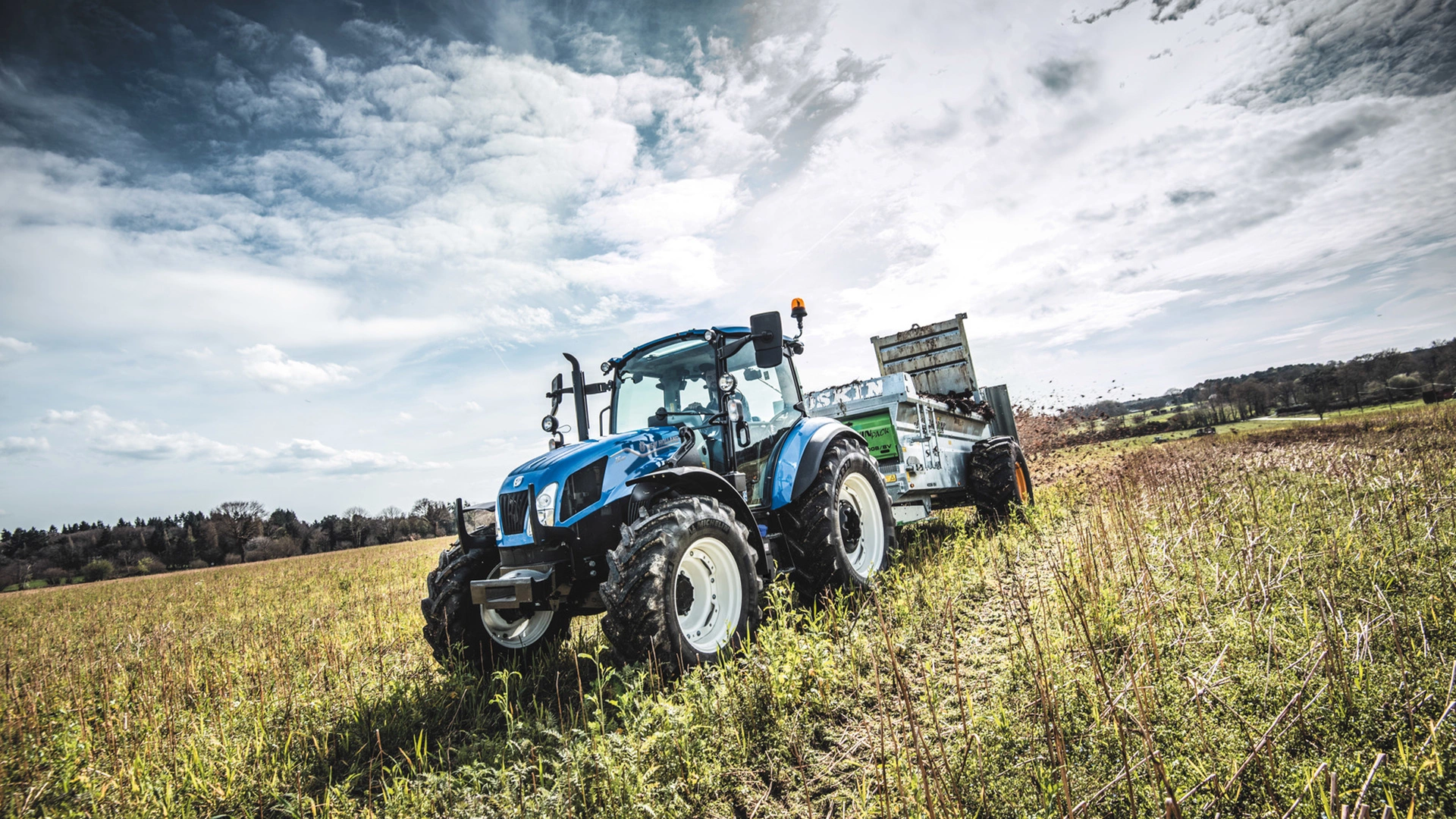 Farm goods transportation underway with New Holland T5 Utility agricultural tractor