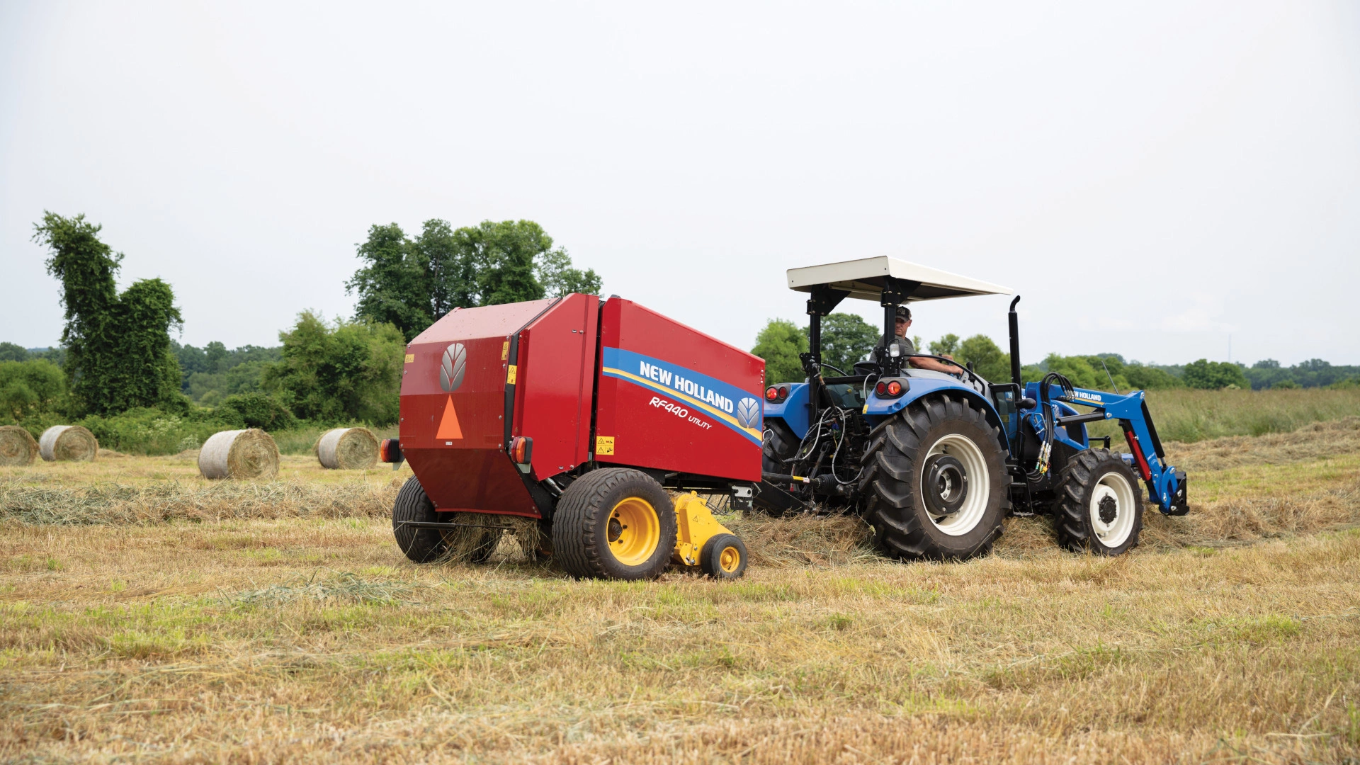 WORKMASTER tractor with baler in the field