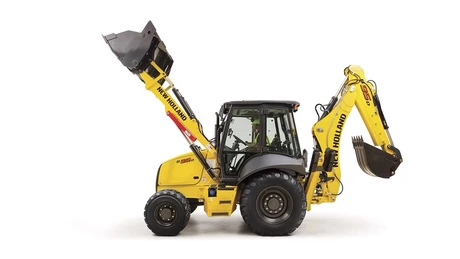 Studio photo of the New Holland B95D backhoe loader, highlighting its side view.