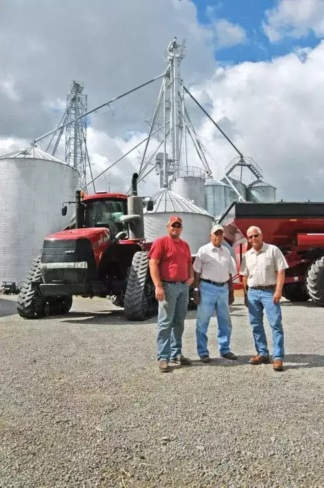 Terry, Darwin and Ryan McClure in front of Steiger Tractor