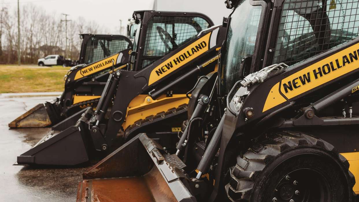 Skid steer loaders line up.