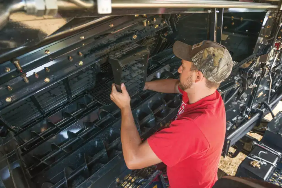 Case IH technician maintaining axial-flow combine