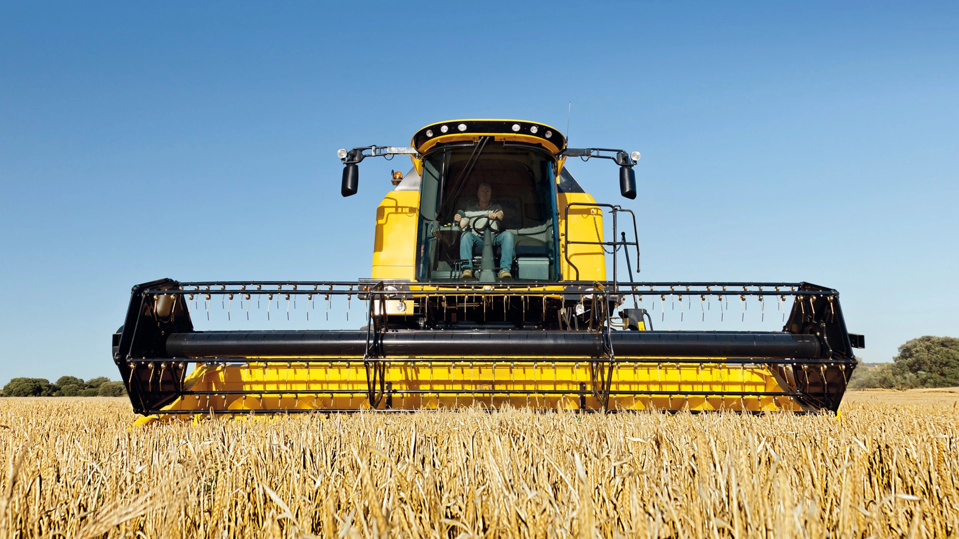 New Holland TC Combine Harvester in action, efficiently harvesting with agricultural combine header